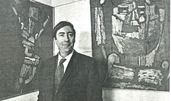 Photograph of Donald Young standing in front of his art